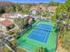 Community tennis court with green turf and blue court at 5144 Conroy Rd # 35, Orlando, FL 32811