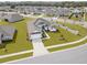 Aerial view of the home showcases the well-manicured lawn and surrounding neighborhood at 530 Sanctuary Blvd, Winter Haven, FL 33881