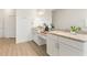 Bright bathroom with double vanity, granite countertops, and wood-look floors at 530 Sanctuary Blvd, Winter Haven, FL 33881