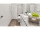 Bright bathroom features a shower and tub combination with marble tile surround and granite countertops at 530 Sanctuary Blvd, Winter Haven, FL 33881