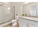 Bathroom featuring a glass-enclosed shower, granite vanity, and wood-look floors at 530 Sanctuary Blvd, Winter Haven, FL 33881