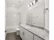 Clean bathroom featuring gray counters, shower-tub combo with tile surround, and wood-look floors at 530 Sanctuary Blvd, Winter Haven, FL 33881