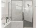 Bathroom features a tub and glass-enclosed shower with marble-look tile at 530 Sanctuary Blvd, Winter Haven, FL 33881