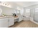 Spacious bathroom with granite countertops, double vanity, and separate tub and shower at 530 Sanctuary Blvd, Winter Haven, FL 33881