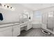 Bright bathroom featuring dual sinks, shower, soaking tub, and modern finishes at 530 Sanctuary Blvd, Winter Haven, FL 33881