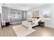 Bright bedroom with a gray accent wall, stylish furniture, and large windows for natural light at 530 Sanctuary Blvd, Winter Haven, FL 33881