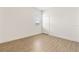 Bedroom with window, wood-look floors, and closet at 530 Sanctuary Blvd, Winter Haven, FL 33881