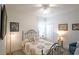 Cozy bedroom featuring a metal bed frame, ceiling fan, and warm lighting at 530 Sanctuary Blvd, Winter Haven, FL 33881