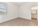 Bedroom featuring wood-look floors, a window, and an ensuite bathroom at 530 Sanctuary Blvd, Winter Haven, FL 33881