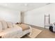 Bedroom with white walls, ceiling fan, wood-look floors, and a cozy seating area at 530 Sanctuary Blvd, Winter Haven, FL 33881