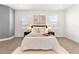 Bright bedroom features modern decor, wood-look floors, and dual windows at 530 Sanctuary Blvd, Winter Haven, FL 33881