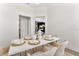 Dining area featuring a modern table, decor, and open-concept living space at 530 Sanctuary Blvd, Winter Haven, FL 33881