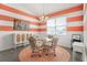 Cozy dining area with unique striped walls, a glass table, and a decorative chandelier at 530 Sanctuary Blvd, Winter Haven, FL 33881