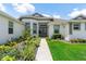 Close up of front entrance with double doors, elegant landscaping, and walkway at 530 Sanctuary Blvd, Winter Haven, FL 33881