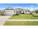 Charming single-story home boasts well-manicured lawn and tasteful landscaping in a suburban neighborhood at 530 Sanctuary Blvd, Winter Haven, FL 33881