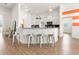Open-concept kitchen with stainless steel appliances and granite countertops with bar seating at 530 Sanctuary Blvd, Winter Haven, FL 33881