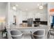 Open-concept kitchen featuring granite countertops, stainless steel appliances, and bar seating at 530 Sanctuary Blvd, Winter Haven, FL 33881