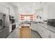 Modern kitchen featuring stainless steel appliances, granite countertops, and a stylish center island at 530 Sanctuary Blvd, Winter Haven, FL 33881