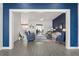 Open-concept living room with hardwood floors and modern decor throughout at 530 Sanctuary Blvd, Winter Haven, FL 33881