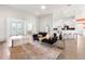 Open-concept living area with modern decor and views of the kitchen and dining room at 530 Sanctuary Blvd, Winter Haven, FL 33881