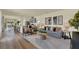 Open living space with gray sofa, hardwood floors, and kitchen view at 5620 Paddock Fence Ln, Apopka, FL 32712