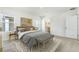 Bedroom with gray bedding and bench, two-toned artwork above bed at 5626 Paddock Fence Ln, Apopka, FL 32712
