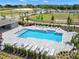 Aerial view of community pool with lounge chairs and surrounding landscaping at 5626 Paddock Fence Ln, Apopka, FL 32712