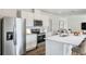 Modern kitchen with white cabinets, stainless steel appliances, and island at 5626 Paddock Fence Ln, Apopka, FL 32712