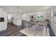 Kitchen and dining area with wood floors and gray chairs at 5632 Paddock Fence Ln, Apopka, FL 32712