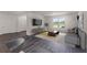 Living room with gray sofa, coffee table, and wood-look floors at 5632 Paddock Fence Ln, Apopka, FL 32712