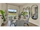 Bright dining room with table, chairs, and mirrors, leading to a view of the backyard at 5879 Galloping Dr, Apopka, FL 32712