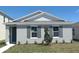 Charming single-story home featuring a well-manicured lawn and quaint window shutters on a sunny day at 5879 Galloping Dr, Apopka, FL 32712