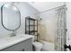 Bathroom with a bathtub, gray vanity, and floating shelves at 625 Greencove Ter # 123, Altamonte Springs, FL 32714