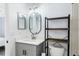 Bathroom with gray vanity, oval mirror, and floating shelves at 625 Greencove Ter # 123, Altamonte Springs, FL 32714