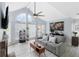 Bright living room with vaulted ceiling, fireplace and gray couch at 625 Greencove Ter # 123, Altamonte Springs, FL 32714