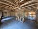 Interior view of a home under construction featuring wood studs, rafters and concrete floors at 649 E Howry Ave, Deland, FL 32724