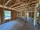 Unfinished room featuring exposed studs, wood rafters, and concrete floors at 649 E Howry Ave, Deland, FL 32724