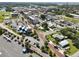 Aerial view of the town with palm trees, roads, houses, and commercial buildings at 662 Sinclair Cir, Tavares, FL 32778