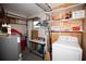 Finished basement with washer/dryer, storage shelves, and additional space at 662 Sinclair Cir, Tavares, FL 32778