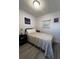 Bedroom with a twin bed, side table, art, wood-look floor, and simple decor for a cozy living space at 662 Sinclair Cir, Tavares, FL 32778
