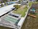 Aerial view of the covered parking, shuffleboard, and the docks with boat slips in the community at 662 Sinclair Cir, Tavares, FL 32778