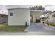 Exterior shot of house with carport featuring a golf cart, and a well-maintained lawn at 662 Sinclair Cir, Tavares, FL 32778