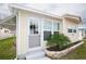 Charming home exterior featuring a well-manicured lawn and stone-lined garden at 662 Sinclair Cir, Tavares, FL 32778