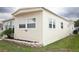 Home exterior features a modern design with clean lines and mature landscaping at 662 Sinclair Cir, Tavares, FL 32778