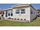 Charming home exterior with well-maintained lawn and landscaping creating an inviting curb appeal at 662 Sinclair Cir, Tavares, FL 32778