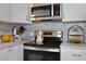Close-up of modern kitchen featuring stainless steel appliances and elegant countertops at 662 Sinclair Cir, Tavares, FL 32778