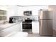 Well-appointed kitchen with white cabinetry, stainless steel appliances, and functional layout at 662 Sinclair Cir, Tavares, FL 32778