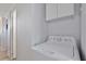 Bright laundry area featuring a modern washing machine and upper cabinets for storage at 662 Sinclair Cir, Tavares, FL 32778