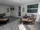 Enclosed patio featuring an area rug, seating, and a comfortable area for relaxation at 662 Sinclair Cir, Tavares, FL 32778