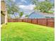 Expansive backyard featuring lush lawn, mature trees, and a sturdy wooden fence for added privacy at 848 Bucksaw Pl, Longwood, FL 32750